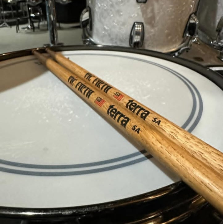 Drum set with a drumstick on an Instagram post interface